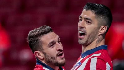 Atletico Madrid's Luis Suarez, right, celebrates with Koke after scoring from the penalty spot to secuire a 2-1 win. AP