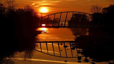 A cyclist rides across the Mimico Creek Bridge in Toronto. Mark Blinch / Reuters