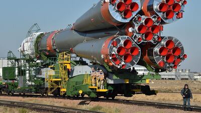 The Soyuz- FG carrier trundles along the back of a train close to the Russian-run Baikonur Cosmodrome in rural Kazakhstan ahead of the launch on Wednesday evening. Vyacheslav Oseledko / AFP