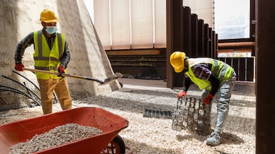 Workers dismantle the Netherlands' Expo pavilion.