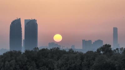 The sunset over Al Reem Island is seen from the Eastern Mangroves area of Abu Dhabi. Victor Besa / The National