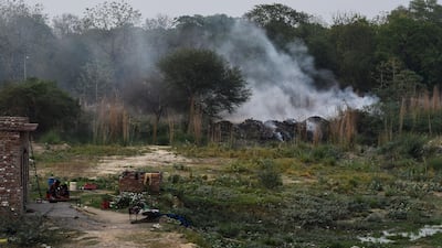 Smoke rises from a burning field near the industrial area in the Indian city of Kanpur. The city of three million people has been smarting since a World Health Organisation (WHO) report last month put Kanpur at the head of 14 Indian cities in the world's top 15 with the dirtiest air. Chandan Khanna / AFP