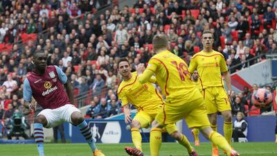Aston Villa’s Christian Benteke, left watches his shot as he scores to level it 1-1 on Sunday against Liverpool in the FA Cup semi-final. Tim Ireland / AP
