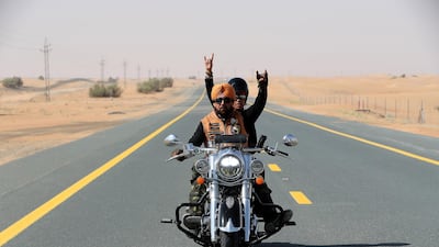 Gurnam Singh, one of the founder of Singhs Motorcycle Club UAE, rides with his 10-year-old son Mehardeep Singh. Pawan Singh / The National