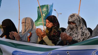 Supporters of Pakistani political and Islamic party Jammat-e-Islami pray for the victims of the Peshawar school massacre. (Aamir Qureshi / AFP)