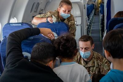 Members of the Royal Air Force welcome Afghan citizens being flown from a third country to the UK. AFP