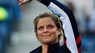 Kim Clijsters waves goodbye to fans at the US Open after her defeat to Laura Robson