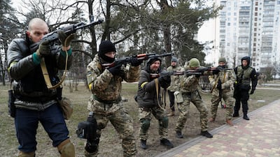 An instructor conducts a military exercise for new members of the Territorial Defence Forces in Kyiv. Reuters