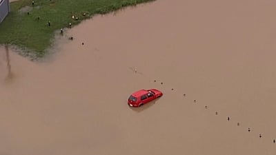 This image from a video shows a submerged car on Gold Coast, Australia. AP