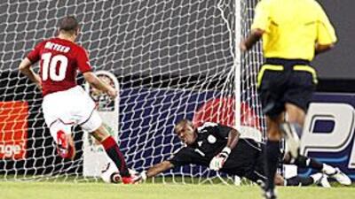 Nigeria's goalkeeper Vincent Enyeama, dives but fails to stop a goal from Egypt's Mohamed Nagui as teammate Emad Motaeb backs up in Benguela, Angola.