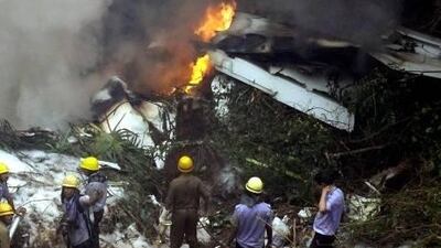 Families of victims killed in crash a year ago say their grief has been compounded by delays in compensation payments by airline insurers.