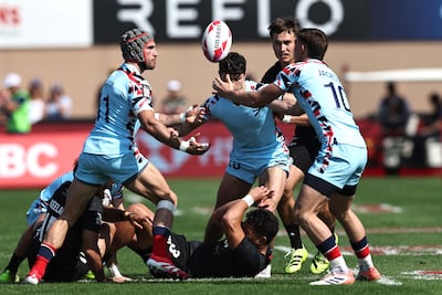 New Zealand's Tone Ng Shiu, on ground, is tackled by Ethan Waddleton and Brent Jackson of Great Britain at the Dubai Sevens. AFP
