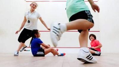 The fitness trainer Sarah Louise Crowther, left, leads a session with young clients Yara Helal, 9, Fouad Helal, 10, and Parisa Ghajar, 10. Sarah Dea / The National