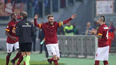 AS Roma's Daniele De Rossi celebrates with his teammates after scoring their second goal in a Serie A win over Cesena on Wednesday at the Stadio Olimpico in Rome. Alessandro Di Meo / EPA / October 29, 2014