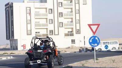 A man drives his buggy in Al Salama neighborhood. Residents say young, unlicensed bikers are making too much noise during sleeping hours. Reem Mohammed / The National