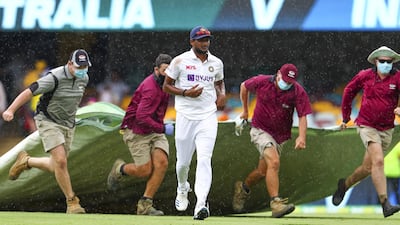 India's Thangarasu Natarajan runs from the field as rain stops play. AP
