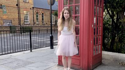 Royal Ballet dancer Meaghan Grace Hinkis stands outside a red telephone box. Reuters