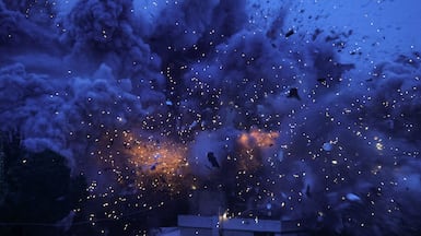 Smoke and sparks at the scene of an Israeli attack on the village of Al Kfour. AFP