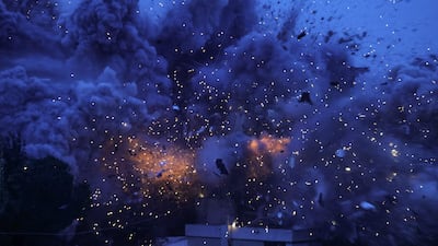 Smoke and sparks at the scene of an Israeli attack on the village of Al Kfour. AFP