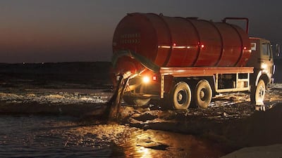 A tanker releases waste at an open sewage site. The foul smell travels to the nearby Mistral Villas. Jeffrey E Biteng / The National