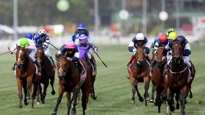 Rekindling, ridden by Australian jockey Corey Brown, (C, pink helmet) wins the Melbourne Cup. Dan Himbrechts / EPA