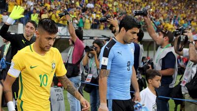 Luis Suarez of Uruguay and Neymar of Brazil. REUTERS/Paulo Whitaker