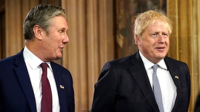 Mr Johnson and Mr Starmer speak in the Central Lobby at the Palace of Westminster. PA
