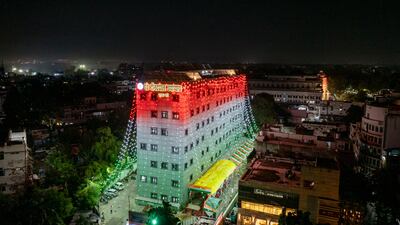 A government building is lit in national colours on the eve of Independence Day in Lucknow. AP