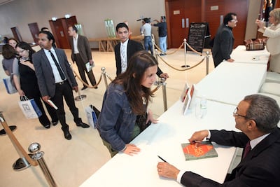 Bahaa Taher signs copies of 'Sunset Oasis' during the Emirates Airline Festival of Literature 2010. Amy Leang / The National