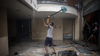 A protester strikes the ceiling inside the Lebanese Banks Association (ABL) headquarters during a demonstration. Bloomberg