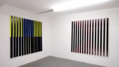 Rana Begum's exhibition at The Third Line, The Moment of Alignment, features a series of large, wall-mounted installations made of aluminium bars grouped into canvas-sized squares.
