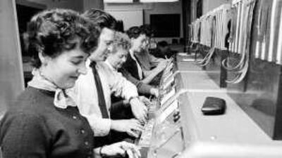 A group of workers operating the tickertape machines at Prestick Airport, near Glasgow.