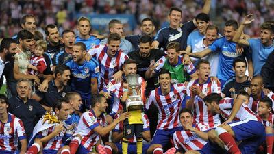 Atletico Madrid players celebrate after beating Real Madrid 1-0 (2-1) on aggregate to win the Spanish Supercopa at the Vicente Caldron on Friday. Denis Doyle / Getty Images