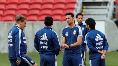 Argentina manager Lionel Scaloni talks to players during the training session. EPA