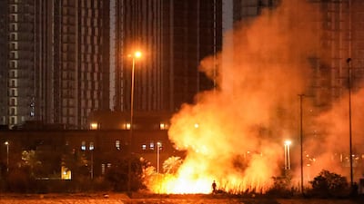A fire burns outside the grounds of the US Embassy headquarters in Baghdad's fortified 'Green Zone' on March 17, 2026. AFP