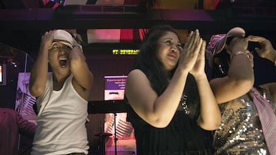 Bon Zues Vilanueva, left, reacts after being selected over Anne Katrina Mella and Loudyryan Laturnas as one of the six people selected to move on to the final round of the Kitakits singing sensation competition in Dubai, July 26, 2011. Sammy Dallal / The National