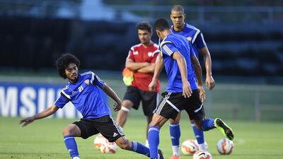 Midfielder Haboush Saleh, left, tries to tackle Mohammed Ahmed as Ismail Ahmed, right, looks on.