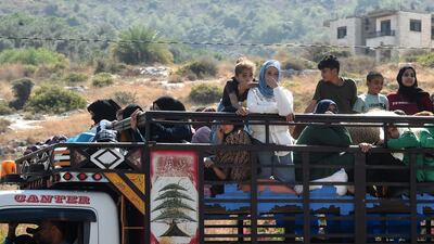 People fleeing southern Lebanon travel with their belongings along the Damour highway towards Beirut. EPA