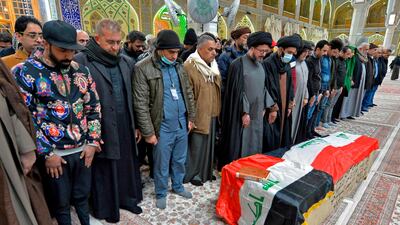 Mourners pray over the coffin of a victim who was killed in a twin suicide bombing in central Baghdad, during a funeral in the holy city of Najaf, Iraq. AFP