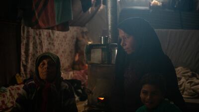 Ms Sido, with family members in their tent in Jindires. Seven people live there, she said, three of whom have permanent disabilities