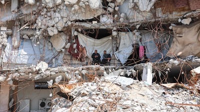 Displaced Palestinians sit outside a makeshift shelter in the rubble of buildings at the Jabalia refugee camp in northern Gaza. AFP