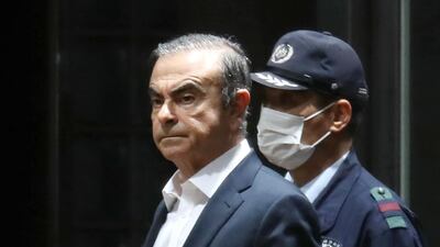 Former Nissan chairman Carlos Ghosn being escorted as he walks out of the Tokyo Detention House following his release on bail in Tokyo, Japan. AFP