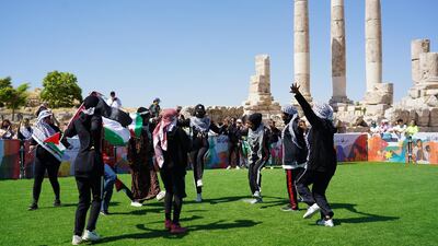 Football players from Gaza camp dance Dabke on the field before their match. Amy McConaghy / The National
