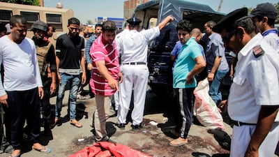 Egyptian policemen inspect the scene of an attack which left five of their colleagues killed in a shooting near Badrashin, a town about 30 kilometres from Cairo, on July 14, 2017. Ahmed Abd El Gawad / AFP