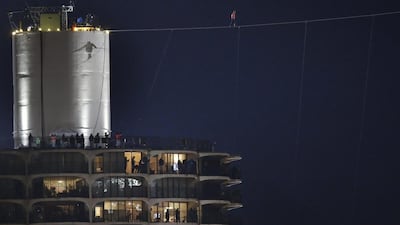 ‘I love Chicago, and Chicago definitely loves me,’ said Mr Wallenda as he walked the wire, with the crowd below him screaming in support. Charles Rex Arbogast/AP Photo