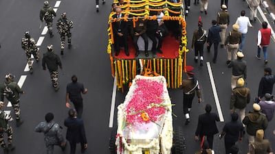 Mr Singh's coffin is carried during his funeral procession in New Delhi. Reuters