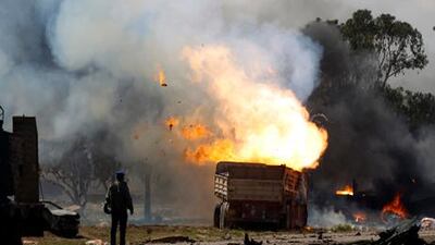 A truck burns after being hit during an air strike.