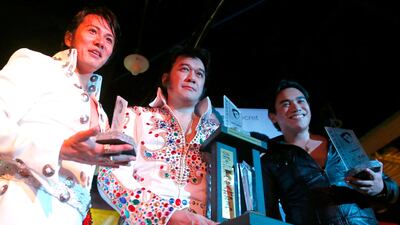 Elvis impersonators and winners of the First Annual Elvis of Asia singing contest pose with their trophies at the conclusion of the competition as they pay tribute to the King of Rock and Roll to mark the 40th anniversary of his death. Bullit Marquez / AP photo