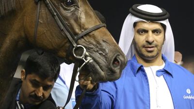 Saeed bin Suroor, the trainer of Be Ready, poses with Songcraft, ridden by Silvestre De Sousa and owned by Godolphin, after it won the Ford Edge Sport Trophy at Meydan Racecourse on February 13, 2014. Razan Alzayani / The National