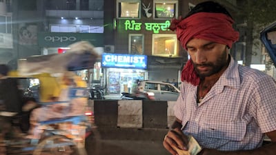 Santosh Yadav, taking money from a passenger. Taniya Dutta for The National